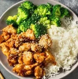 Crockpot teriyaki chicken served with rice and vegetables