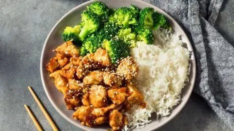 Crockpot teriyaki chicken served with rice and vegetables