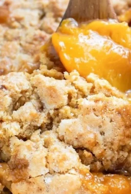 Delicious gluten-free peach cobbler topped with a golden crust and fresh peaches