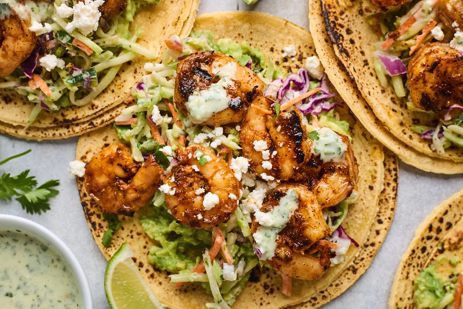 Grilled shrimp tacos served with cilantro lime slaw on a plate
