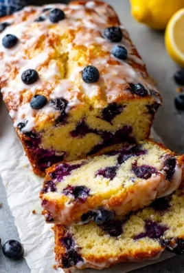 Delicious lemon blueberry loaf cake sliced on a wooden board