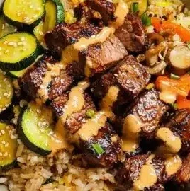 Delicious hibachi steak bowls served on a plate with colorful vegetables
