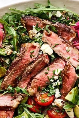 Steak Salad with Arugula and Blue Cheese garnished with fresh ingredients