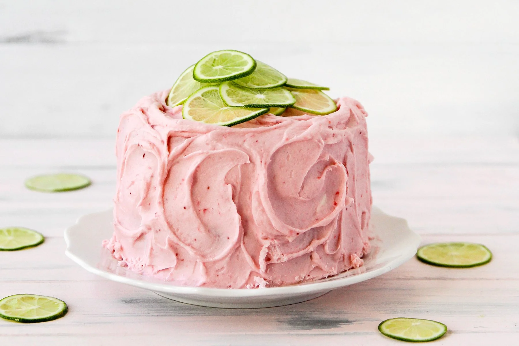 Slice of delicious Strawberry Limeade Cake topped with fresh strawberries