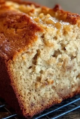 Super moist banana bread fresh out of the oven, sliced and served on a plate.