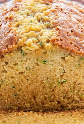 Slice of homemade zucchini bread on a wooden table
