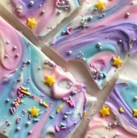 Colorful Unicorn Yogurt Bark with sprinkles, fruit, and yogurt, a fun frozen snack.