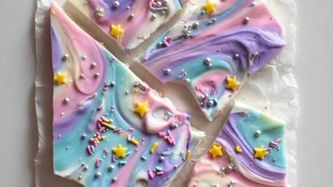 Colorful Unicorn Yogurt Bark with sprinkles, fruit, and yogurt, a fun frozen snack.