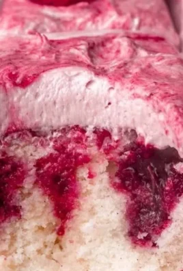 Slice of White Chocolate Raspberry Cake on a decorative plate.