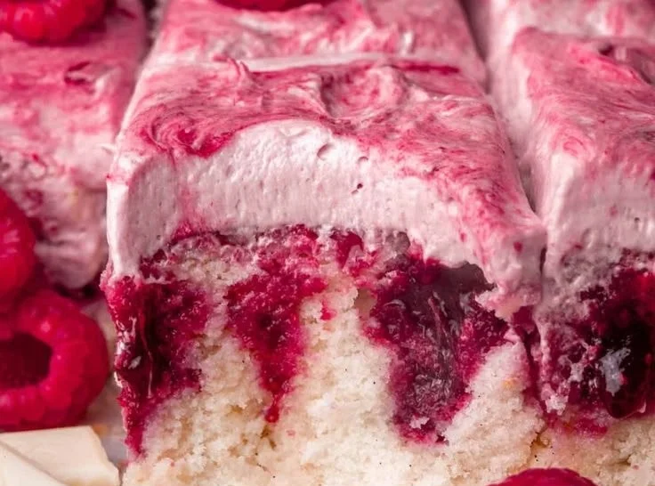 Slice of White Chocolate Raspberry Cake on a decorative plate.